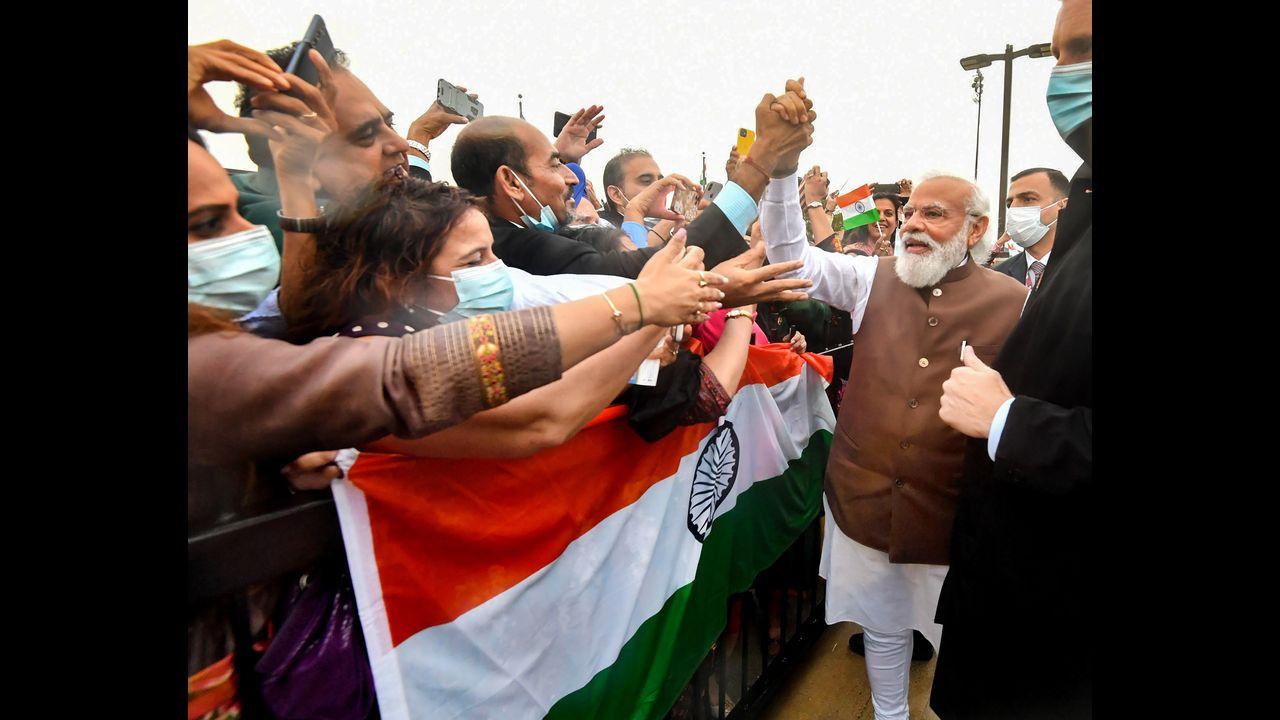 More than a hundred members from the Indian community gathered at the airport to welcome the Indian leader. Pic/PTI